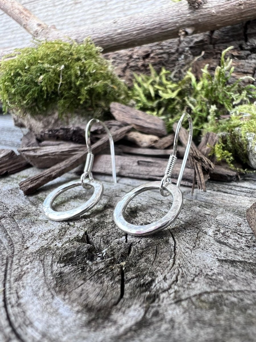 Recycled sterling silver circle drop earrings styled on moss-covered weathered wood, Isle of Wight handmade jewellery
