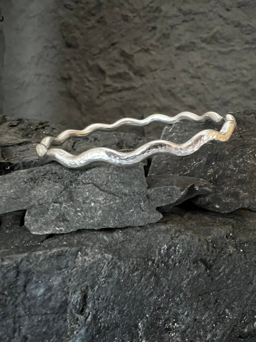 Sterling Silver Textured Wave Bangle (3.5 mm) Sat on Charcoal blocks