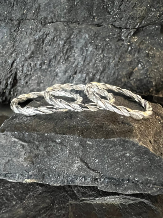 Three Sterling Silver Thin Round Twist Rings (1.2 mm) Close up View on Slate - Kerry Gallop Jewellery