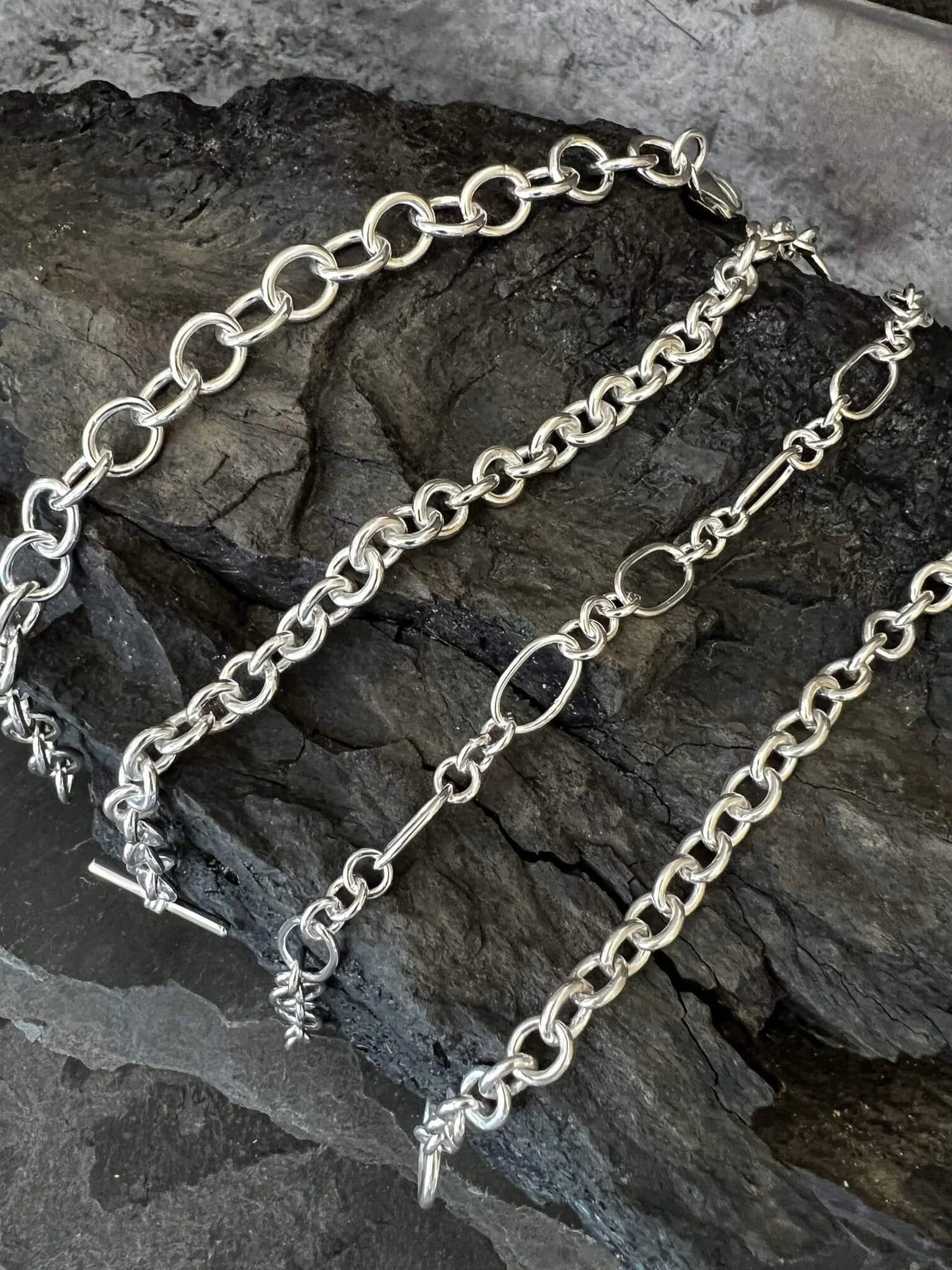 Four Chains Draped across a Piece of Charcoal - Kerry Gallop Jewellery