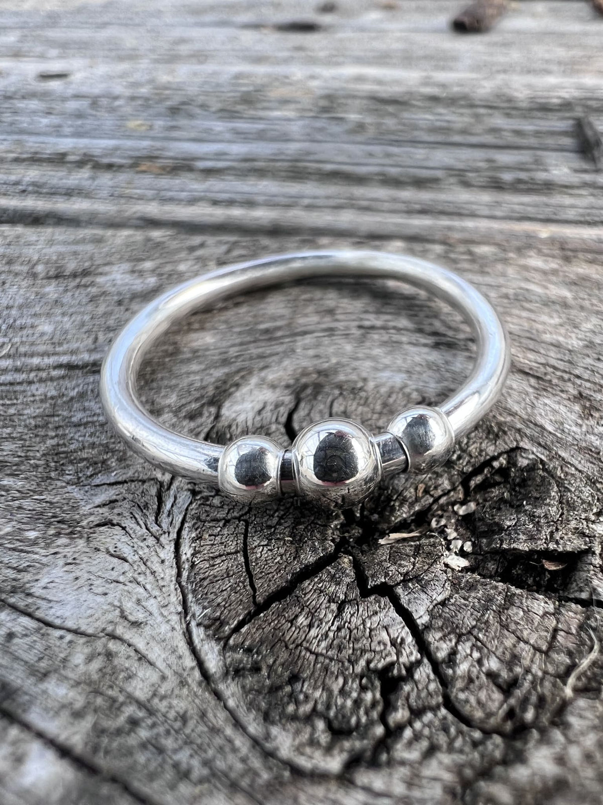 Recycled sterling silver beaded spinner ring on weathered driftwood, handmade anxiety ring Isle of Wight