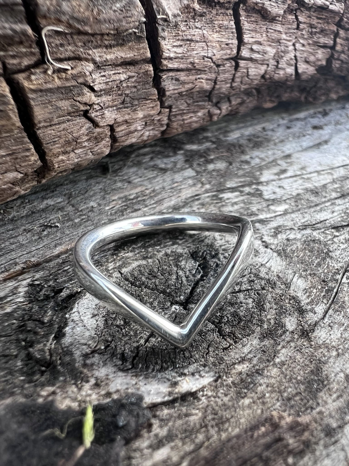 Recycled sterling silver chevron ring on weathered driftwood, handmade Isle of Wight jewellery