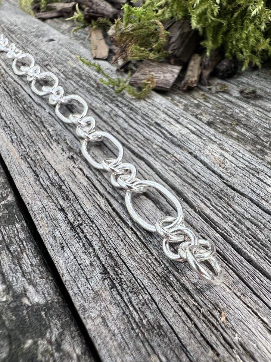 Recycled sterling silver fetter and three link bracelet on weathered wood, handmade Isle of Wight jewellery