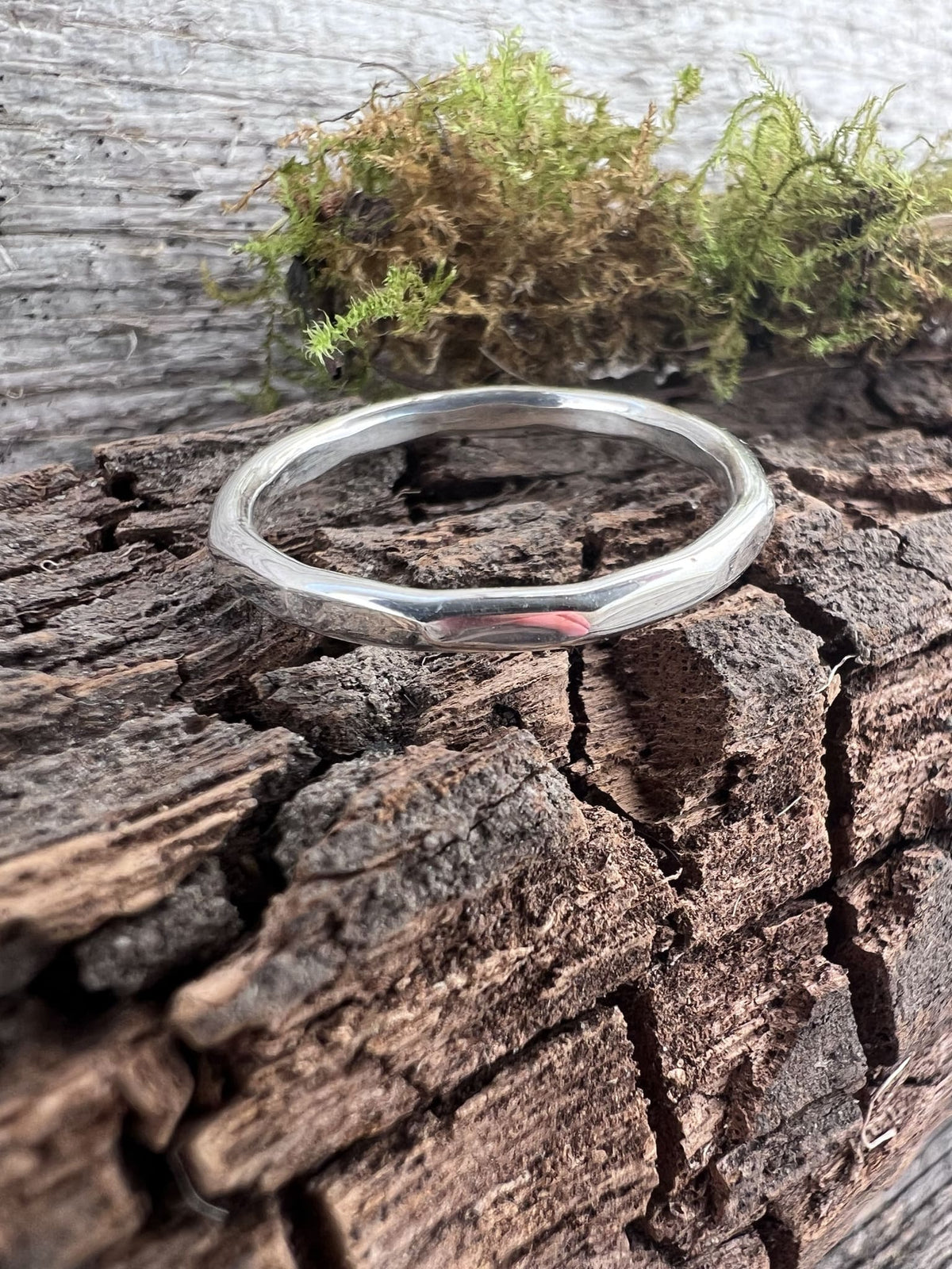 Recycled sterling silver flat hammered ring on mossy driftwood, handmade Isle of Wight jewellery