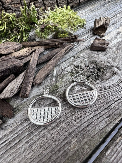 Recycled silver lattice halo drop earrings on weathered wood with foliage, showing both earrings and lattice work