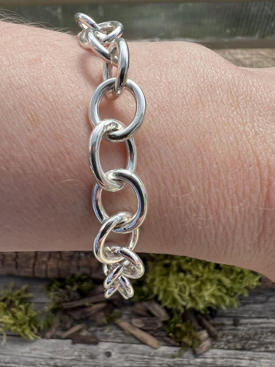 Recycled sterling silver Lina trace bracelet worn on a wrist, showing the large oval chain links and scale