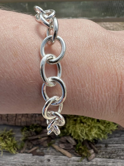 Recycled sterling silver Lina trace bracelet worn on a wrist, showing the large oval chain links and scale