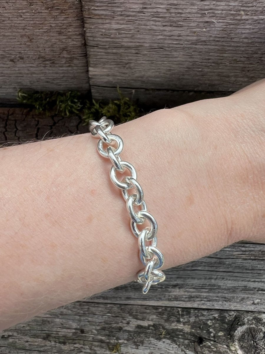 Recycled sterling silver Nova oval loop bracelet worn on a wrist, showing the bold oval chain links