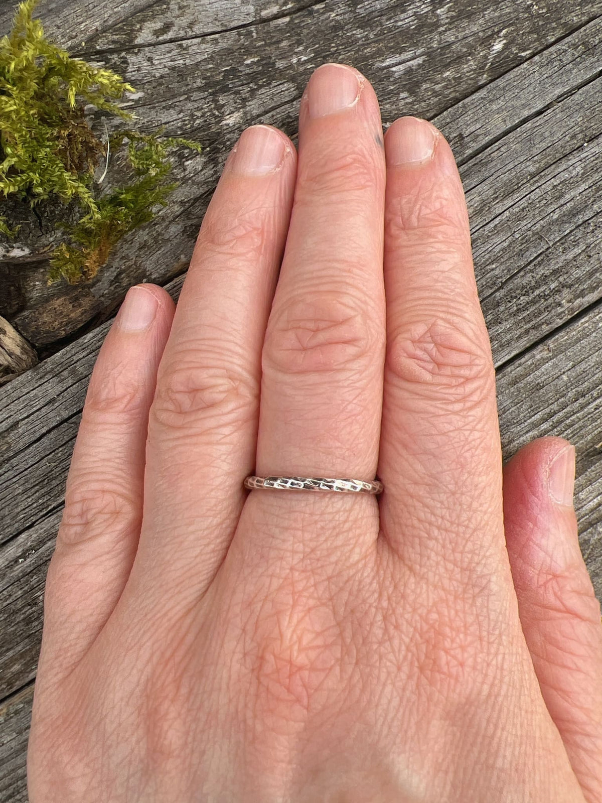 Sterling silver sparkle cut ring worn on a finger, showing scale and how the faceted band catches the light