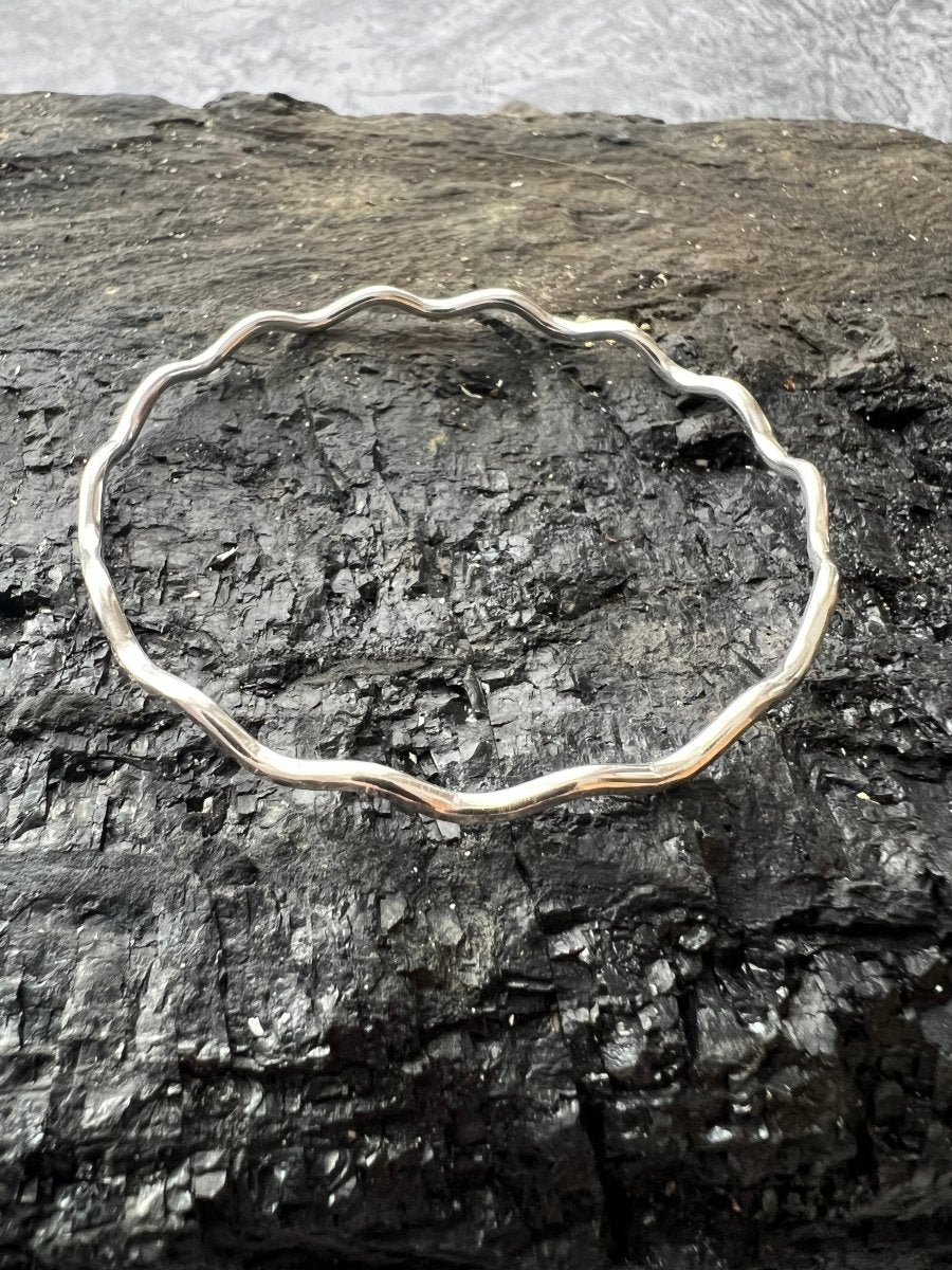 Sterling Silver Textured Wave Bangle (3 mm)  Front view on Charcoal Piece- Kerry Gallop Jewellery